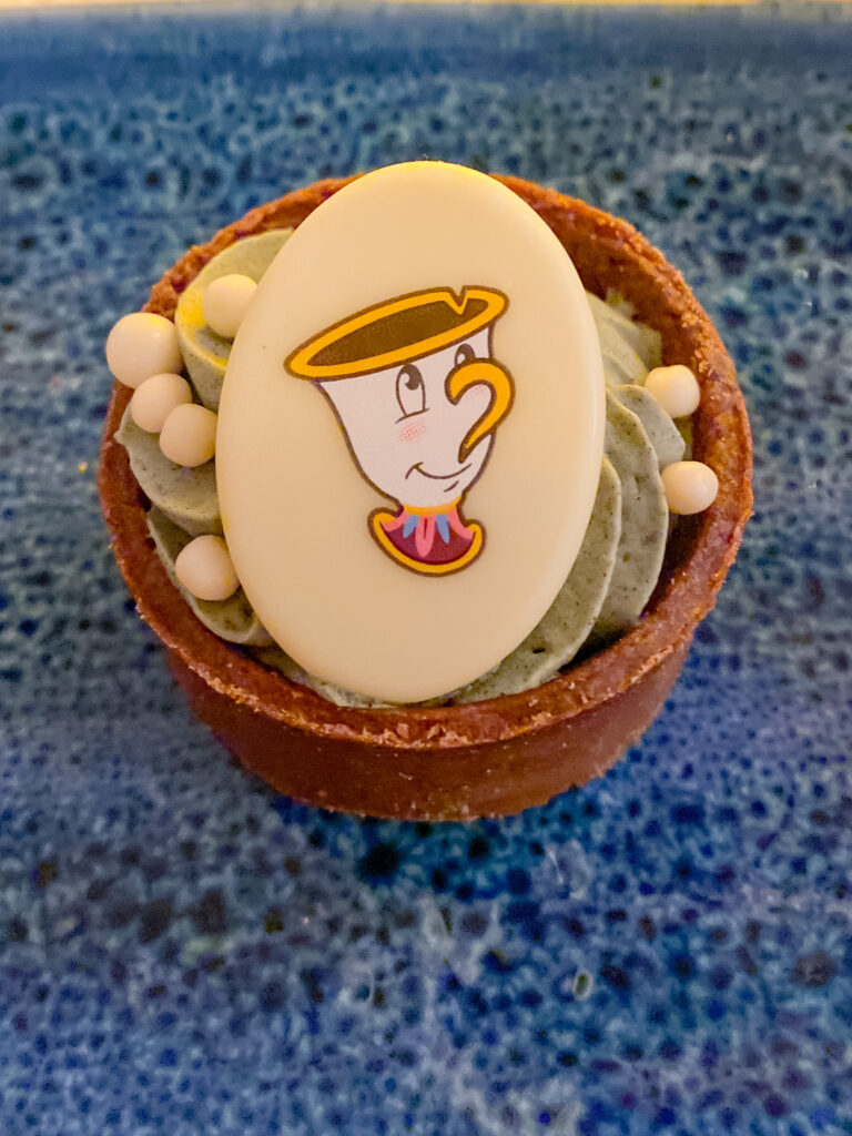 the grey stuff cup with chocolate coin Disney Be Our Guest Restaurant Review