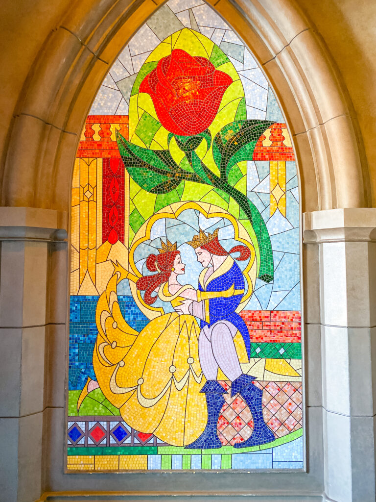 stained glass window with Belle and Prince Adam dancing at Be Our Guest restaurant in Magic Kingdom